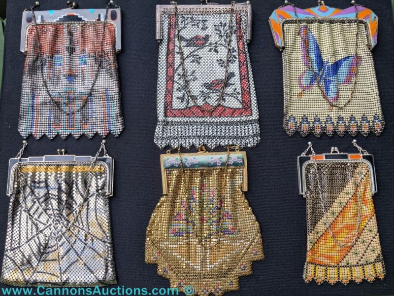 Six vintage mesh purses arranged in two rows, each with unique Art Deco or floral motifs, multicolor enamel or metal frames, scalloped or fringed mesh edges, and chain handles, photographed for the Incredible Vintage Purses & Handbags Auction in Jetersville VA.
