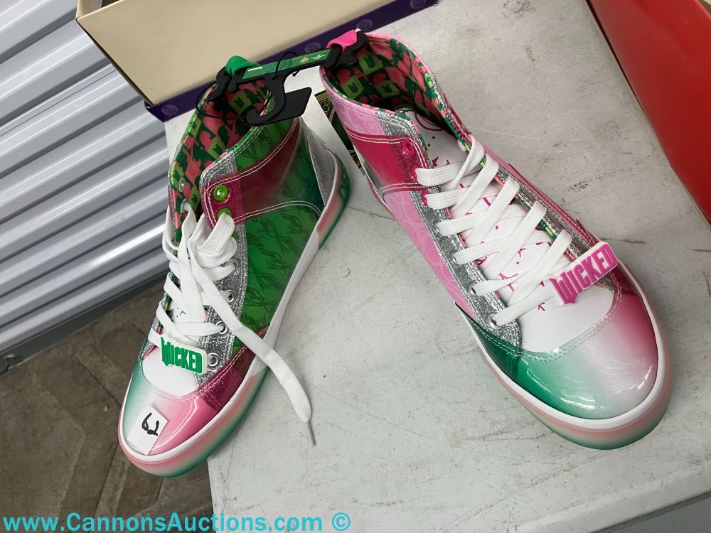 New pair of Wicked movie high-top sneakers, size eight, in pink, green, and silver tones with Wicked logo details and white laces