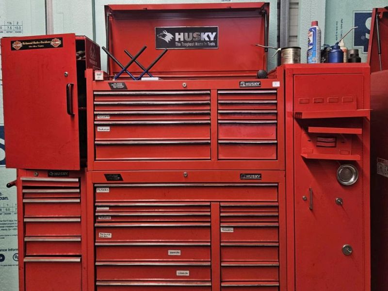 Husky red rolling tool chest and cabinet set with multiple drawers, top lid compartment, and side storage; measures 19" x 69" x 64".