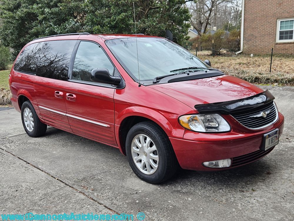 Low mileage 2003 Chrysler Town & Country LXi minivan for sale at Richmond VA estate auction, red exterior with alloy wheels and tinted windows, 3.8L V6 engine, automatic transmission, under 54,000 miles