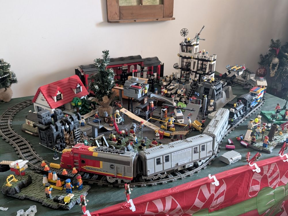Large LEGO building set lot including Xtreme Sports SkateCity, LEGO City 7237 Police Station, train sets, soccer stadium, and Building Bonanza set with storage box