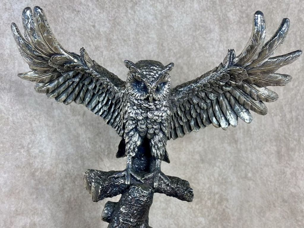 Mexican Plata Artistica sterling silver-coated sculpture of a flying owl with wings spread, perched on a tree branch base, marked Plata .999, 13.5 inches high by 14.5 inches wide.