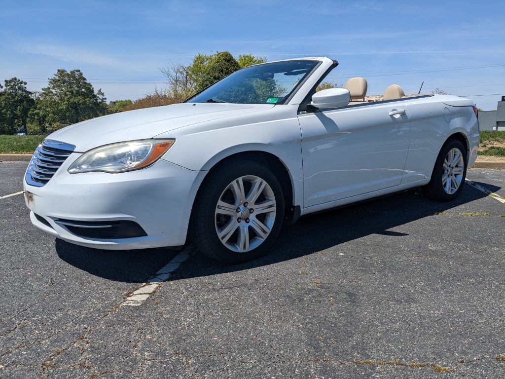 2012 Chrysler 200 Touring convertible in white with tan interior, shown with top down, 2.4L 4-cylinder engine, odometer reading 152,681 miles