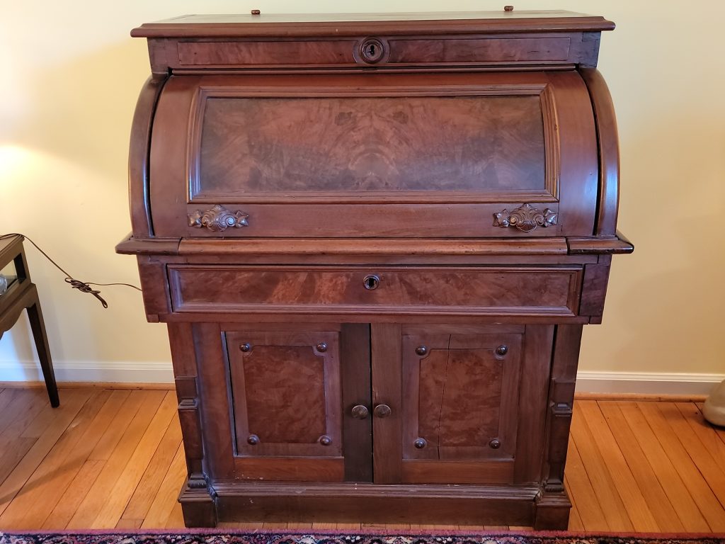 Antique Victorian walnut cylinder roll top desk with burl veneer accents and lower cabinet doors, 36 inches wide, 22 inches deep, and 44 inches tall.