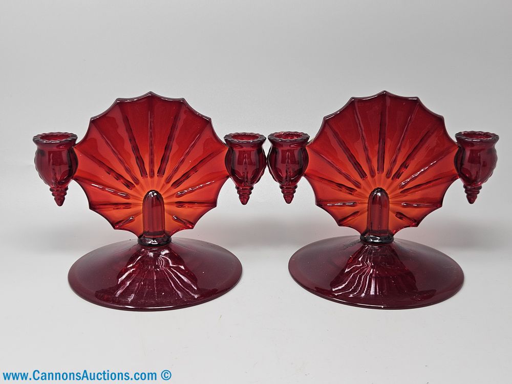 Pair of New Martinsville Radiance ruby red glass candle holders with fan-form backplates and double cup arms, each measuring 6 inches tall