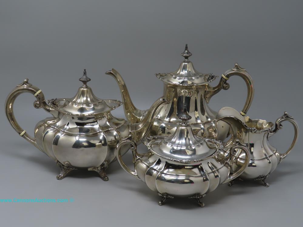 Reed & Barton Hampton Court sterling silver four-piece tea set with teapot, coffee pot, covered sugar, and creamer