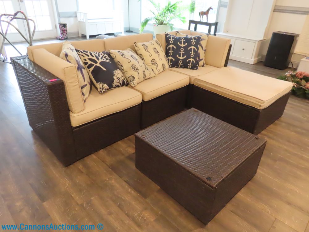 All-weather wicker sectional couch with beige cushions and nautical-themed pillows, featured in the Stanbrook Dr Richmond VA online auction; measures 29" x 83" x 25".