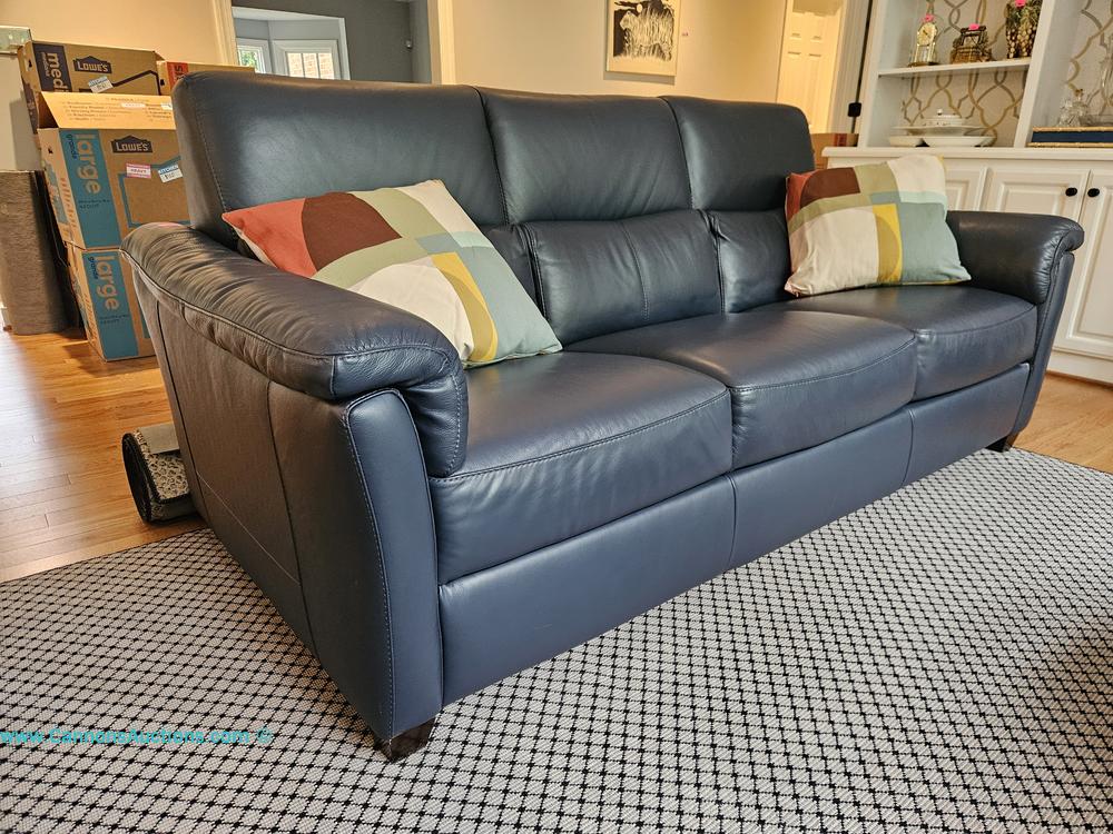 Blue leather sofa with three cushions and two multicolored pillows, 39 x 86 x 39 inches, in the Goochland County Onsite Auction Fairstead Road Manakin Sabot VA 23103