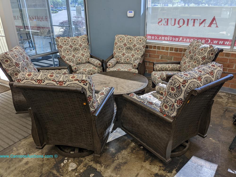 Castelle outdoor patio set with six cushioned swivel chairs and round metal table in bronze finish, table measures 19" x 44" x 44"