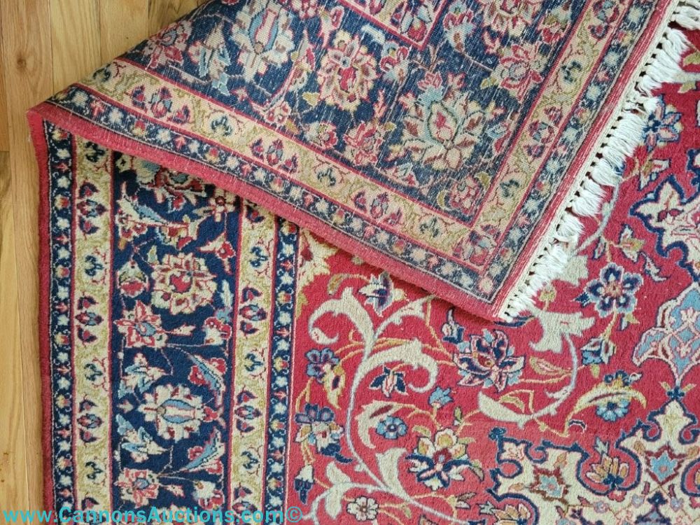 Hand woven Persian Najafabad wool rug with red field, floral medallion, dark border, and traditional design, 137 x 91 inches