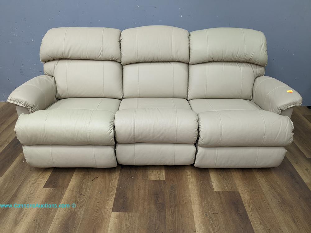 La-Z-Boy beige leather reclining sofa with wooden handles, three cushioned seats, padded arms, and high backrests; measures 36" x 82" x 32"