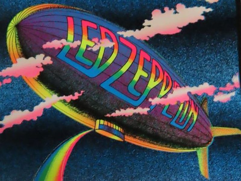 Led Zeppelin “Stairway to Heaven” blacklight poster with zeppelin, rainbow stairway, clouds, and winged figure; measures 35" x 23"