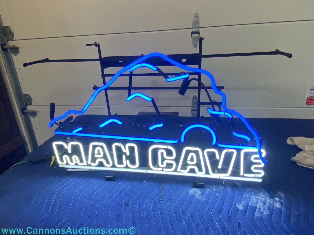 Man Cave neon sign with blue mountain outline and white lettering, measuring 32" wide x 20" tall, featured in the F and L Auctions Richmond VA online estate auction.