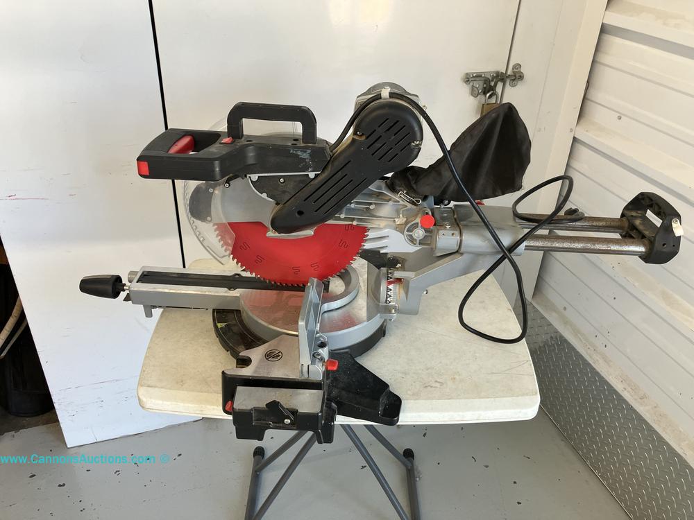 Admiral 12-inch dual-bevel sliding compound miter saw with red blade on folding table