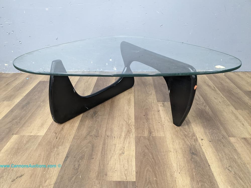Noguchi style glass top coffee table on black wooden sculptural base; measures 16 x 50 x 38 inches