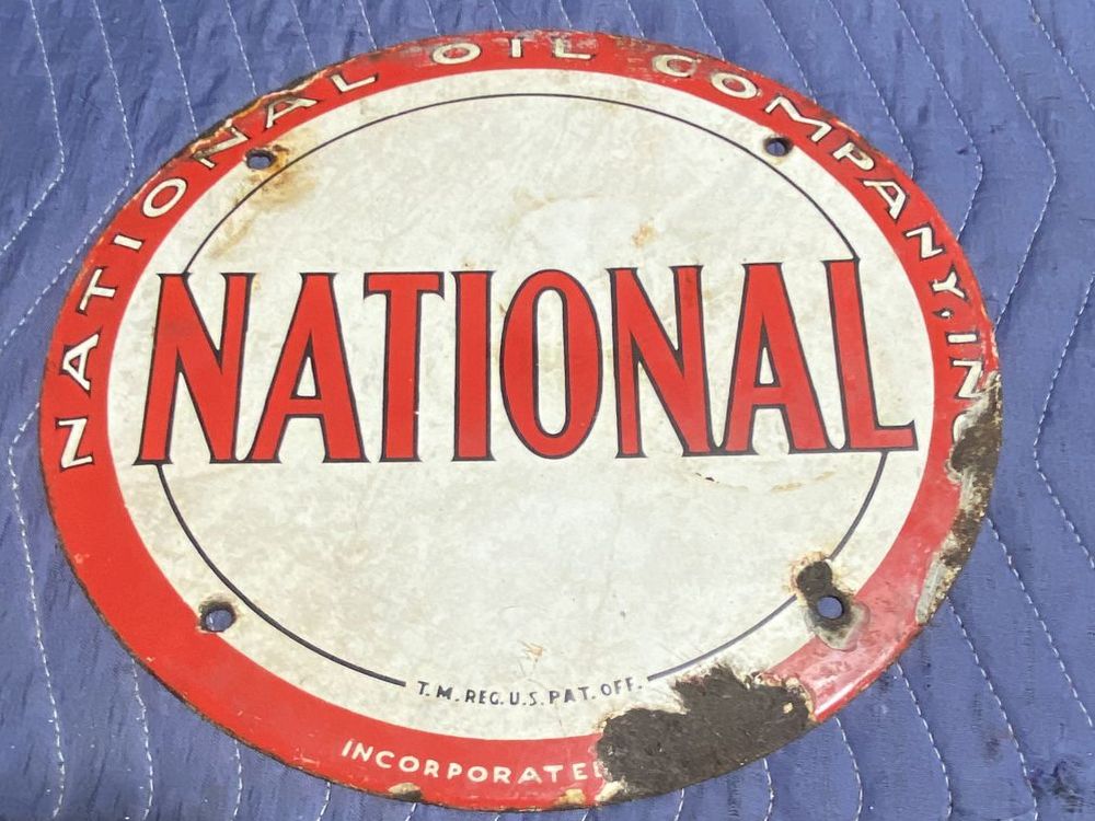 Vintage National Oil Company round porcelain sign with red and white lettering, 12 inches in diameter
