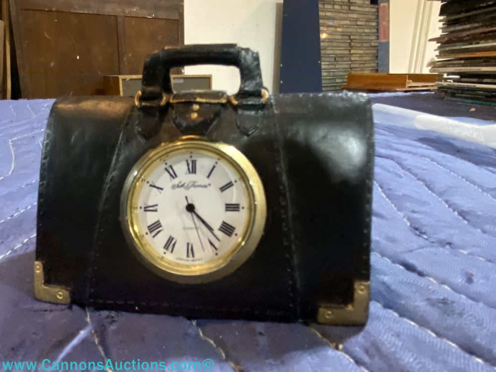 Small vintage Seth Thomas desk clock in black leather-style case with brass-tone trim and Roman numeral face