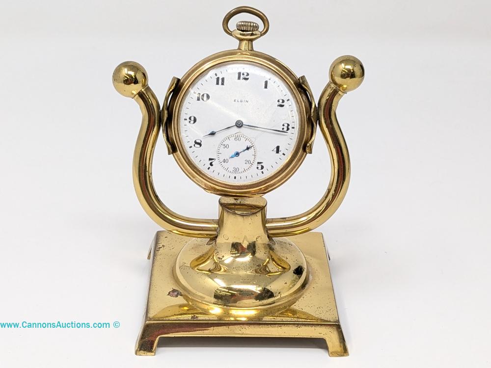 Elgin open-face pocket watch in a 14K solid gold hinged case displayed on a gold-tone desk stand