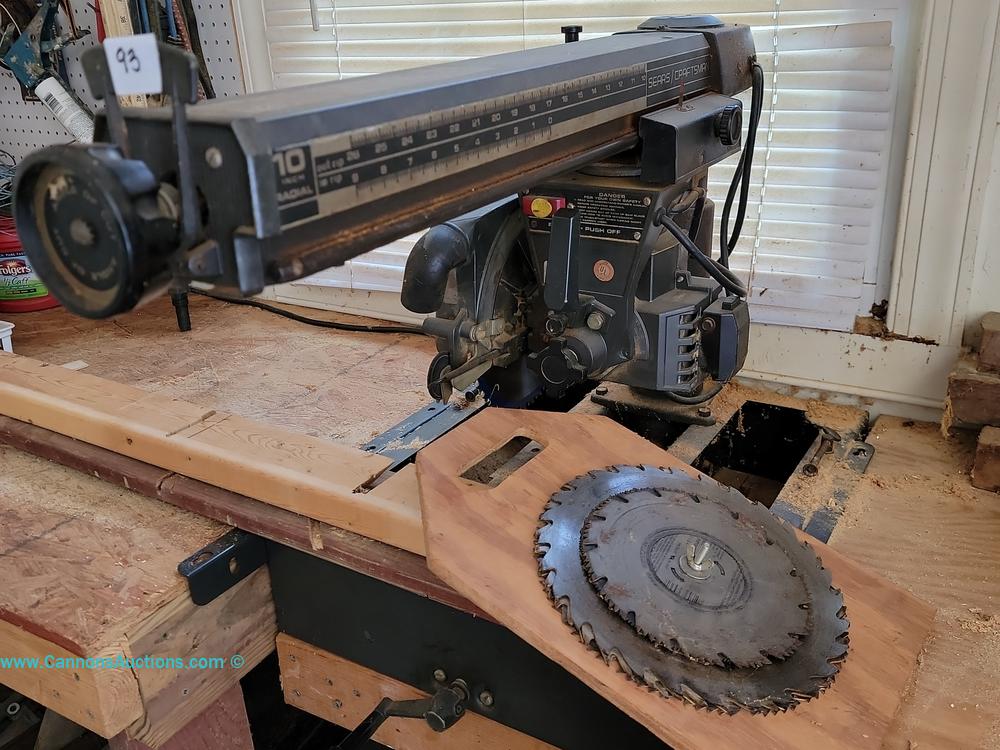 Sears Craftsman 10-inch radial arm saw with attached table and stacked circular saw blades