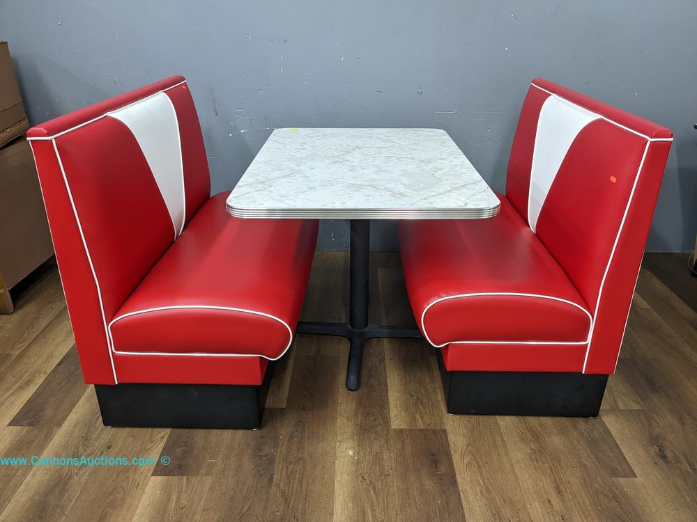 1950s retro diner dinette set with two red and white upholstered benches and faux marble laminate pedestal table