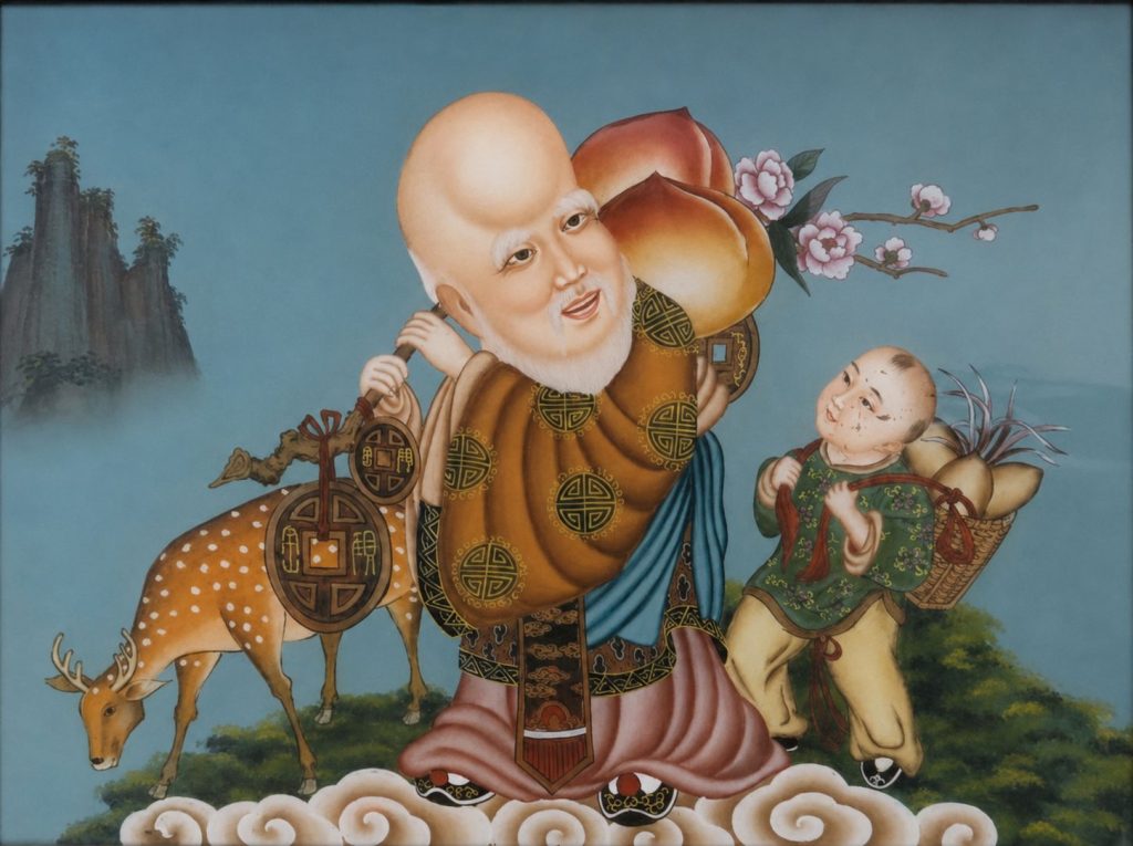 Chinese-style longevity painting depicting Shou Xing, the god of longevity, carrying peaches beside an attendant and deer, with flowering branches and mountains in the background.