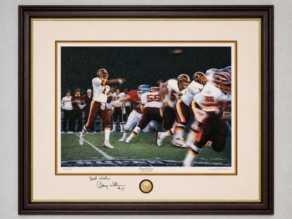 Daniel A. Moore limited edition “Winged Victory” Super Bowl XXII football print, numbered 2183 of 5000, framed with Doug Williams #17 signature and commemorative medallion.