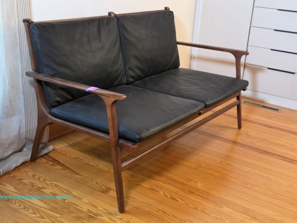 Stellar Works Mid-Century style two-seat sofa with wooden frame, curved arms, and removable custom black leather cushions.