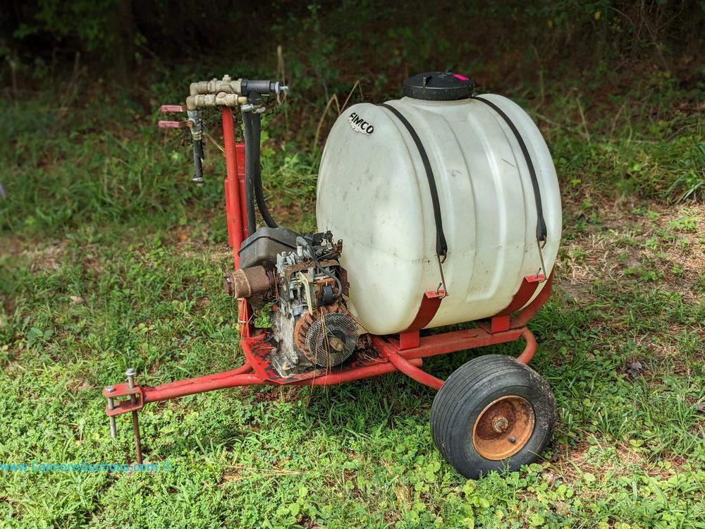 Fimco tow-behind sprayer with large plastic tank, gasoline engine, rear wheels, and spray controls on a metal frame; measures 37 x 45 x 29"