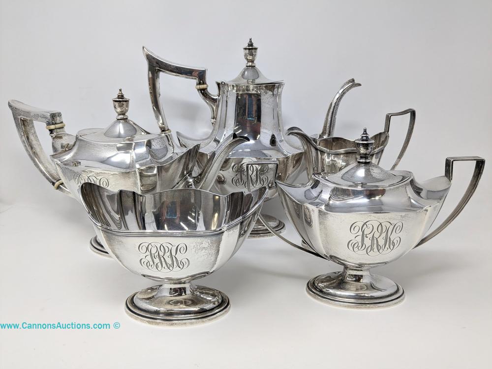 Five-piece Gorham sterling silver coffee and tea service in Plymouth pattern with monograms, pedestal feet and angular handles.