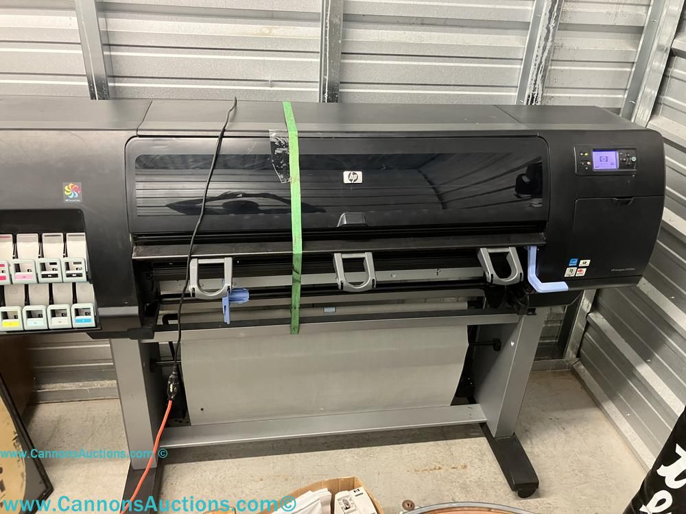 HP Designjet model Q6653A wide-format inkjet printer with display panel and group of HP 91 ink cartridges