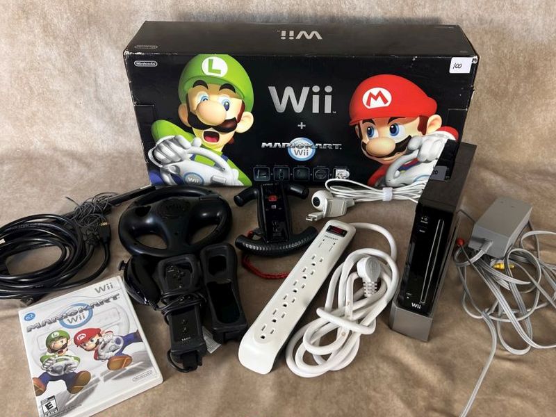 Black Nintendo Wii Mario Kart bundle with Wii console, Mario Kart Wii game, steering wheels, controllers, cables, accessories, and original box.