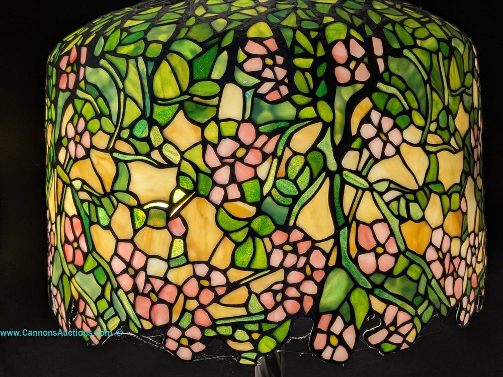 Tiffany-style Cherry Blossom floral stained glass table lamp with pink and yellow flowers, green leaves, bronze tree trunk base, three lights and pull chains