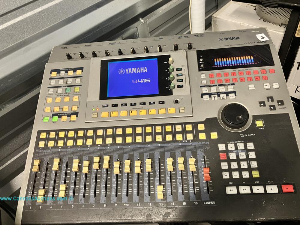 Yamaha AW4416 professional audio workstation with digital mixer, sampling pads, faders, and control display