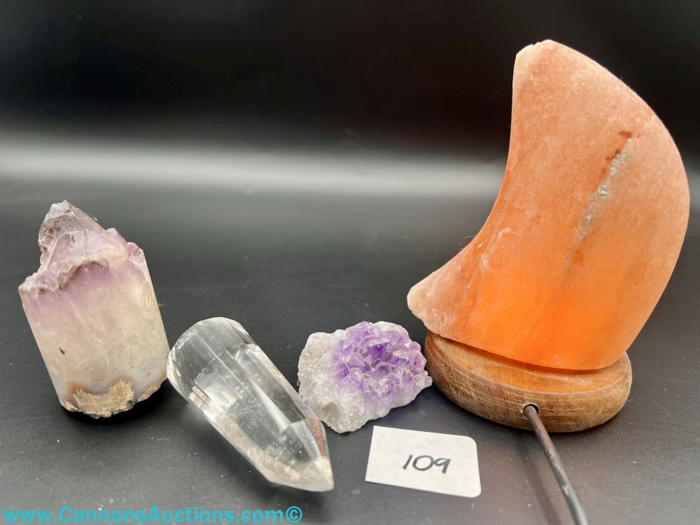 Collection of crystals and mineral specimens, including a crescent-shaped Himalayan salt lamp, featured in Aga's Consignments online auction in Providence Forge, VA.