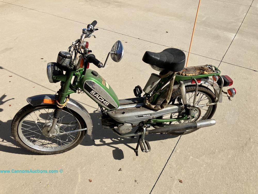 Vintage green Sachs Balboa motorized moped with pedals, front and rear lights, rear carrier, and chrome exhaust, offered at Richmond VA online auction.