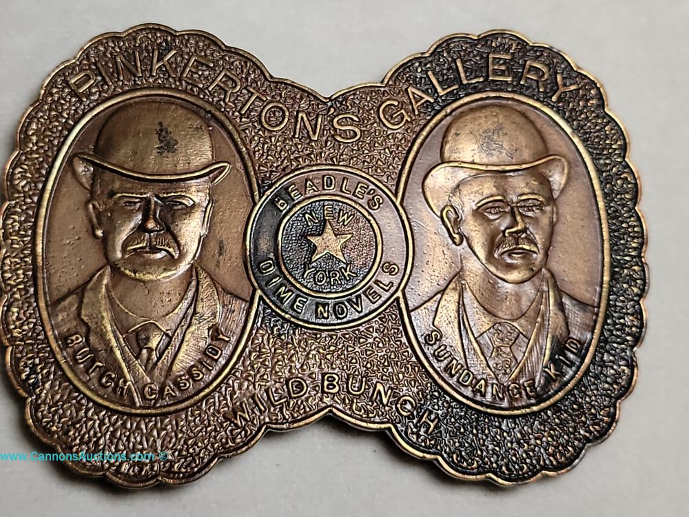 Collection of collectible belt buckles including Pinkertons Gallery Butch Cassidy and Sundance Kid, Smith & Wesson, and Colt Revolvers, Glen Allen estate auction.
